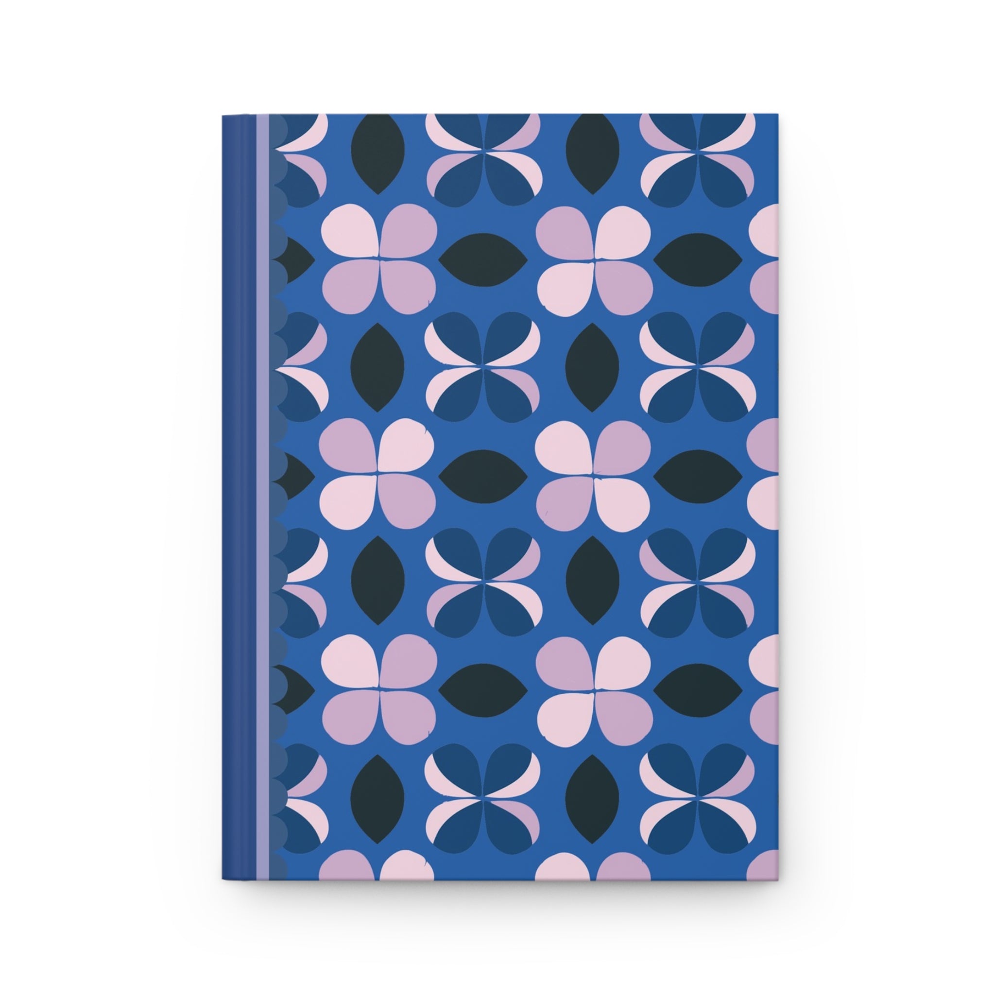 A matte hardcover journal with a blue spine and a cover featuring a pattern of pink, black, and blue flower shapes, this customizable Printify Hardcover Journal Matte comes complete with lined pages.