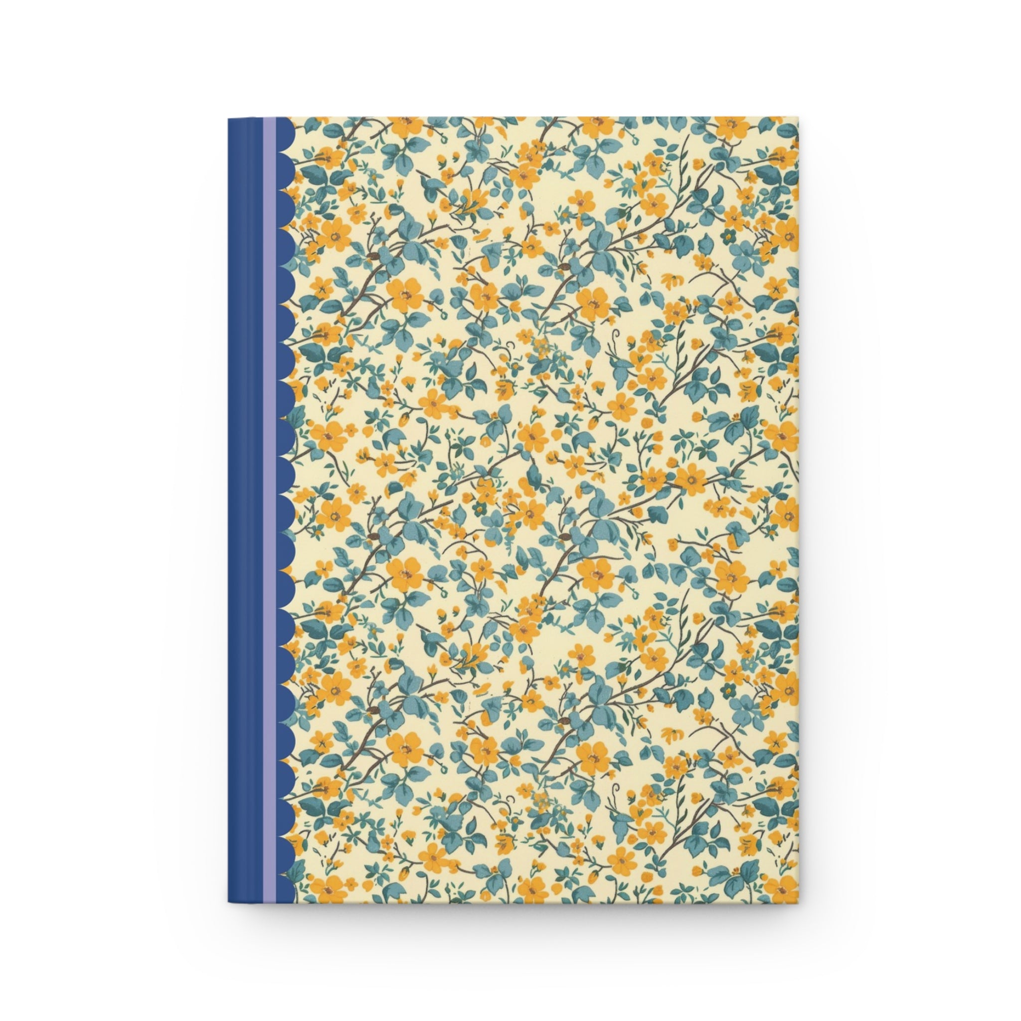 A customizable Printify Hardcover Journal Matte with a floral cover design in yellow and blue, featuring a navy blue spine with a lace pattern along the edge. This hardcover journal boasts a matte finish that adds an elegant touch to its vibrant appearance.