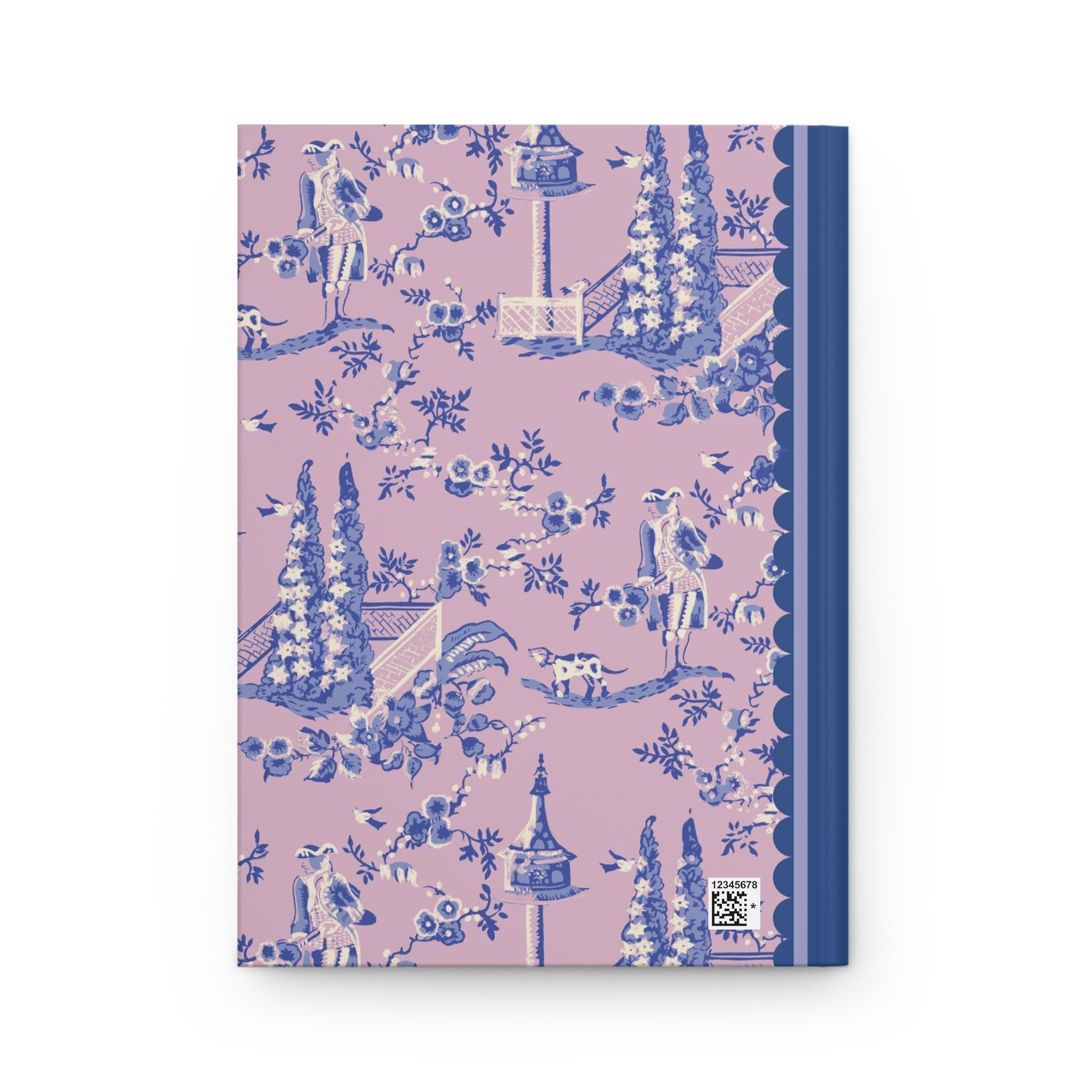 A Hardcover Journal Matte with a pink cover featuring a blue and white pastoral design. The pattern includes trees, flowers, birds, and people. There is a blue spine on the right edge. This customizable journal from Printify comes with lined pages for all your writing needs.