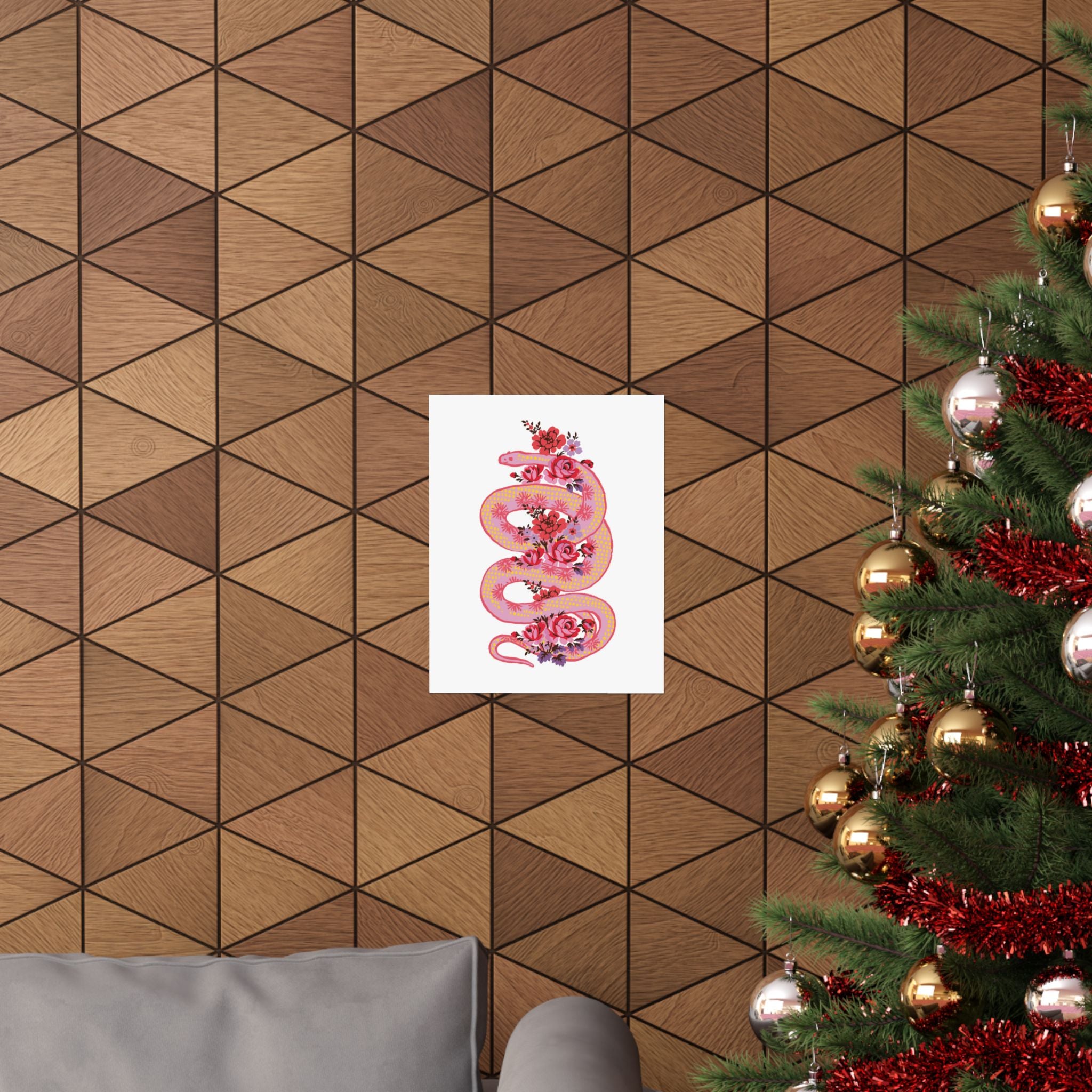 The "Snake with Roses" large matte poster by Printify, printed on museum-grade paper with archival inks, is framed and displayed on a geometric wood wall near a decorated Christmas tree and gray sofa.