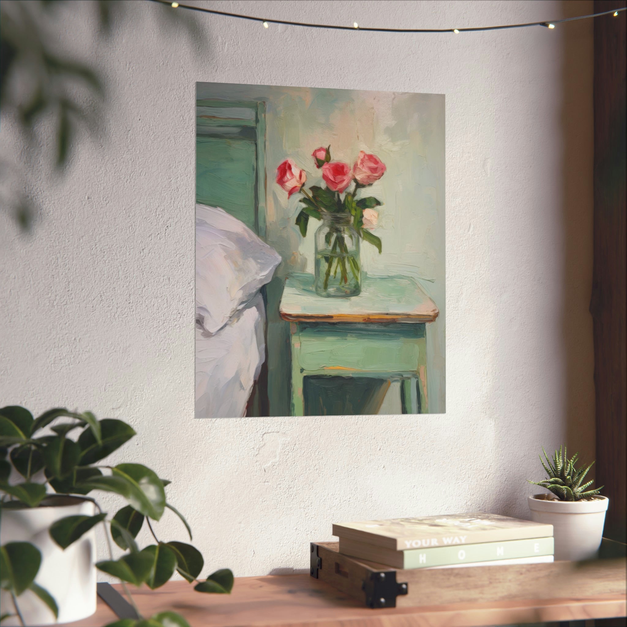 A serene interior scene with a When You Sleep Large Matte Poster by Printify above a neat stack of books and a small potted plant beside it, all beneath a string of decorative lights.