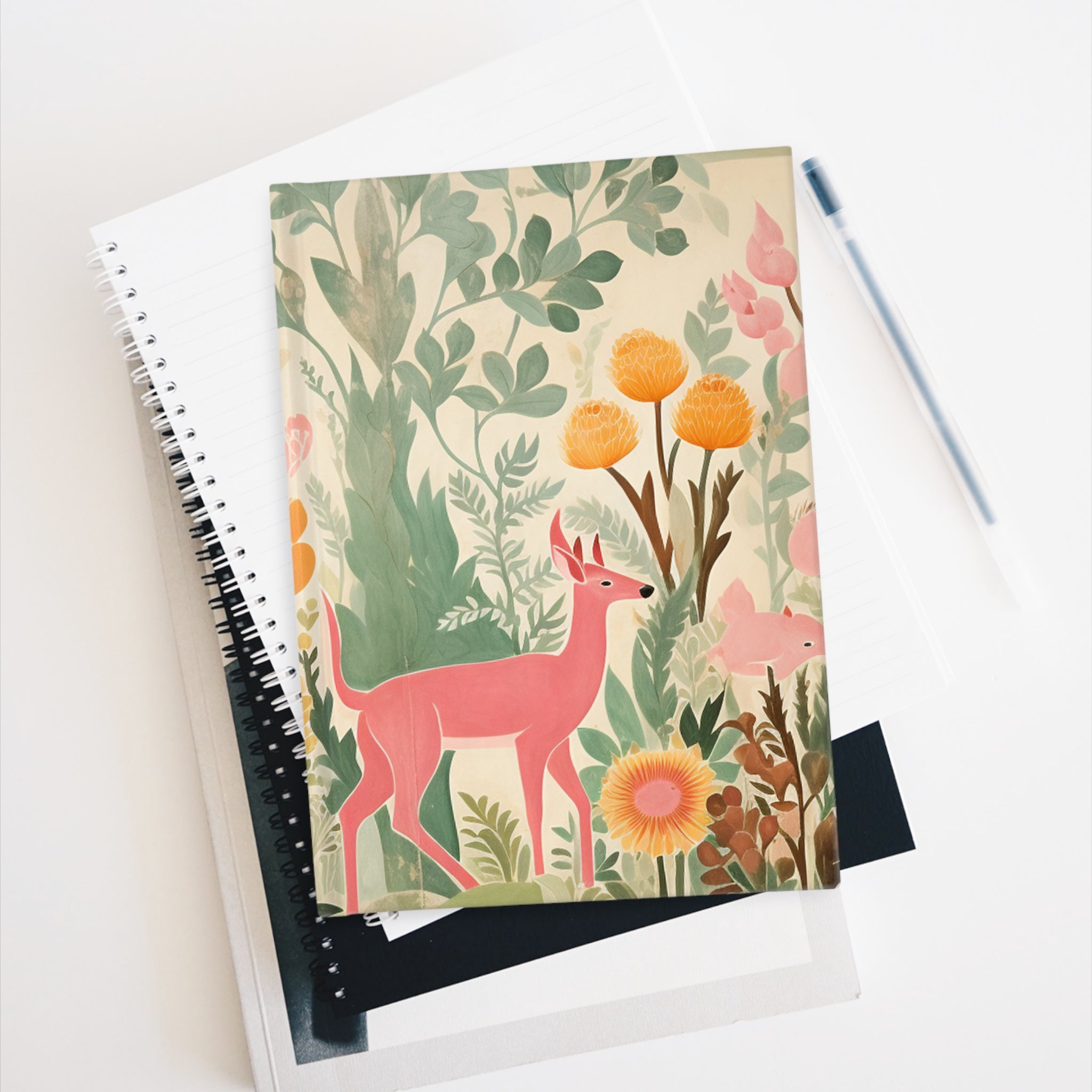 A hardcover Pink Deer Journal - Blank Pages with a wraparound Printify featuring a pink deer and flowers on its blank pages.