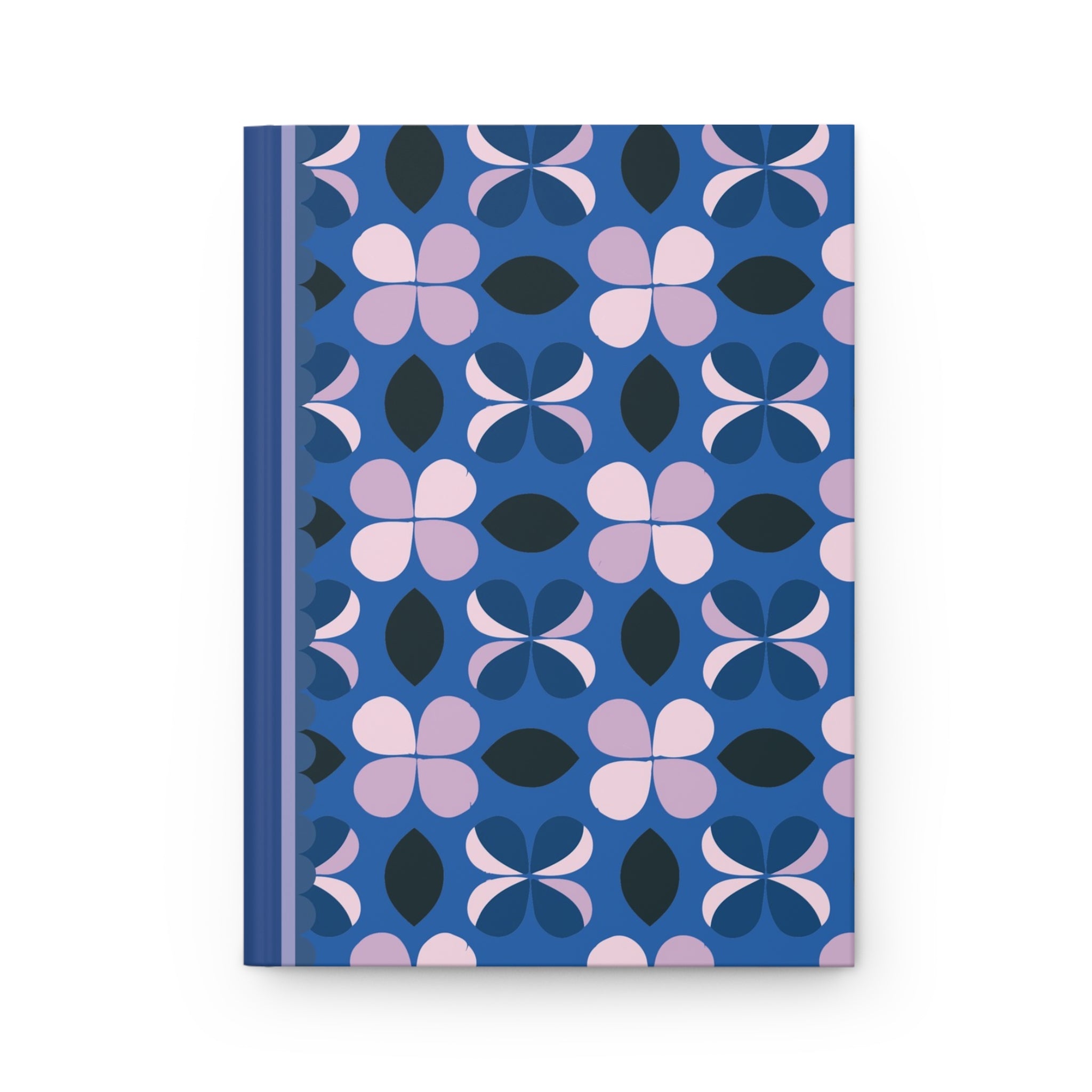 A matte hardcover journal with a blue spine and a cover featuring a pattern of pink, black, and blue flower shapes, this customizable Printify Hardcover Journal Matte comes complete with lined pages.