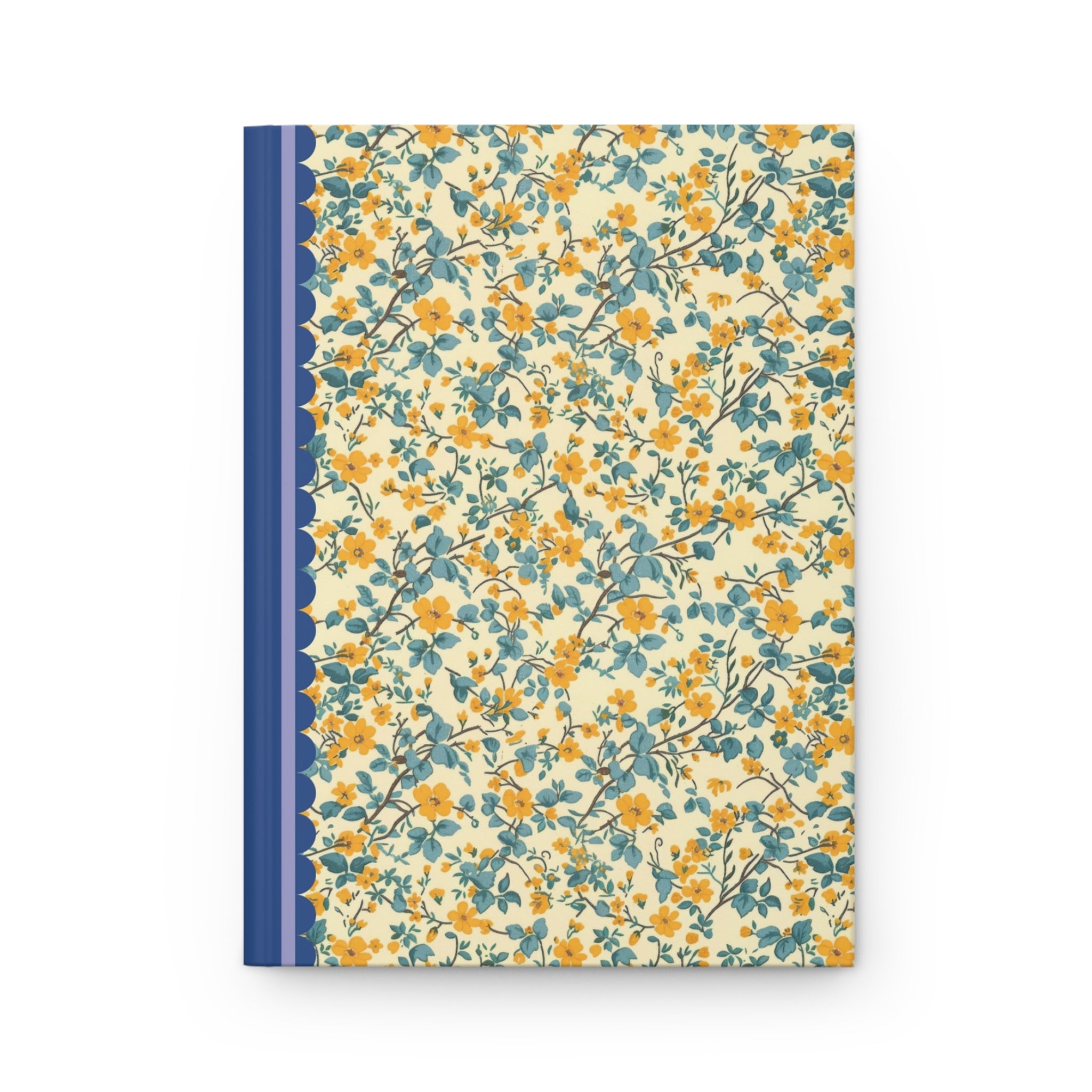 A customizable Printify Hardcover Journal Matte with a floral cover design in yellow and blue, featuring a navy blue spine with a lace pattern along the edge. This hardcover journal boasts a matte finish that adds an elegant touch to its vibrant appearance.