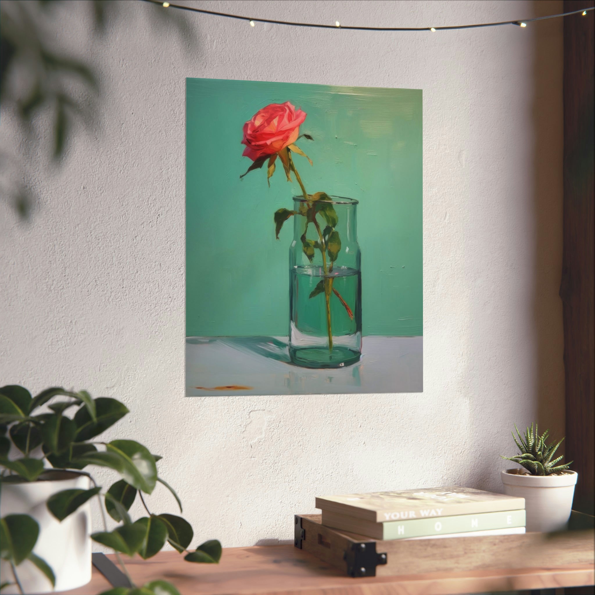 A wall art for living room depicting a solitary rose in a glass vase hangs on a wall above a shelf adorned with small potted plants featuring "Glass of Water in Greens" by Printify.