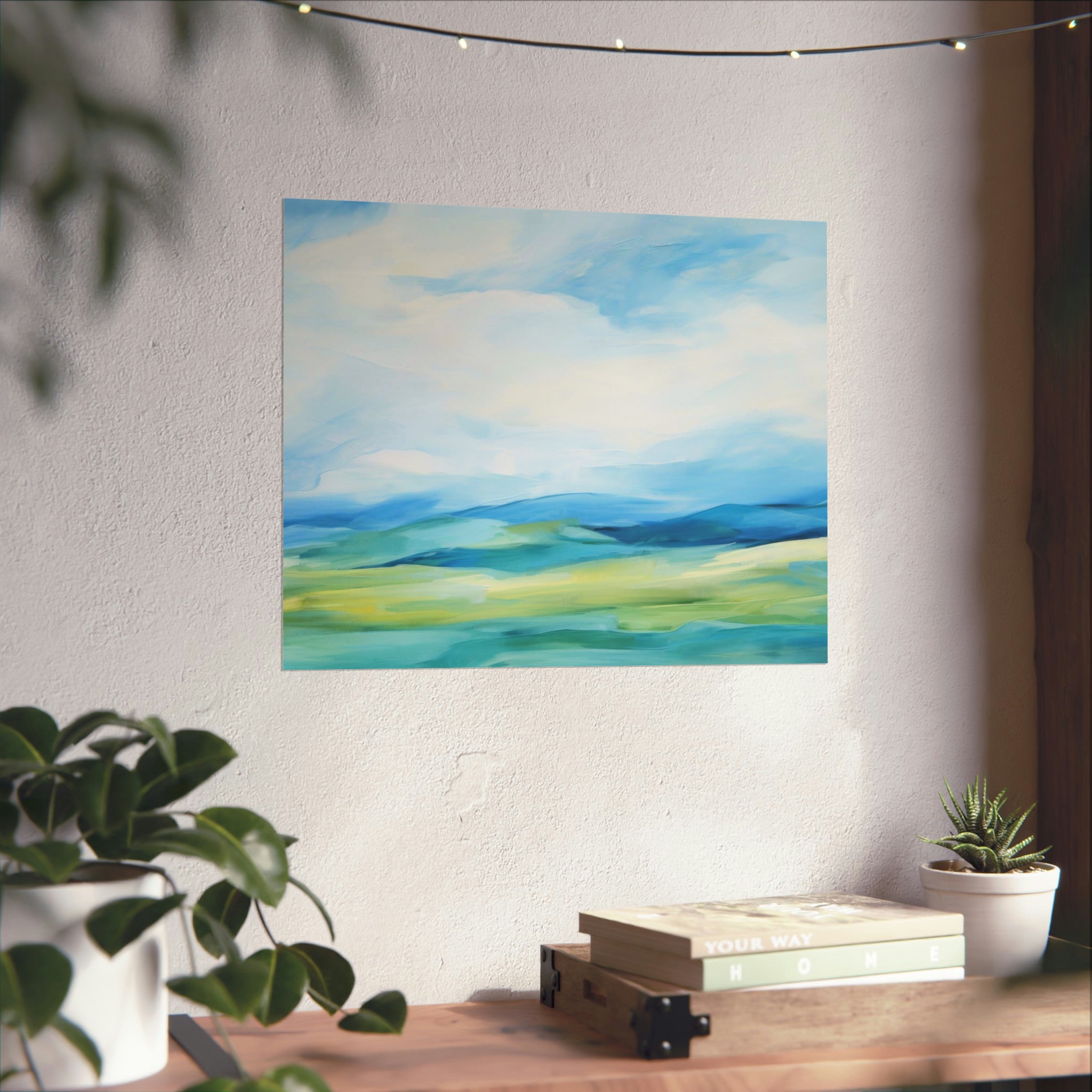 Art prints Distant Blues | Large Matte Poster | 3 Sizes by Printify on a wall above a stack of books and beside indoor plants.