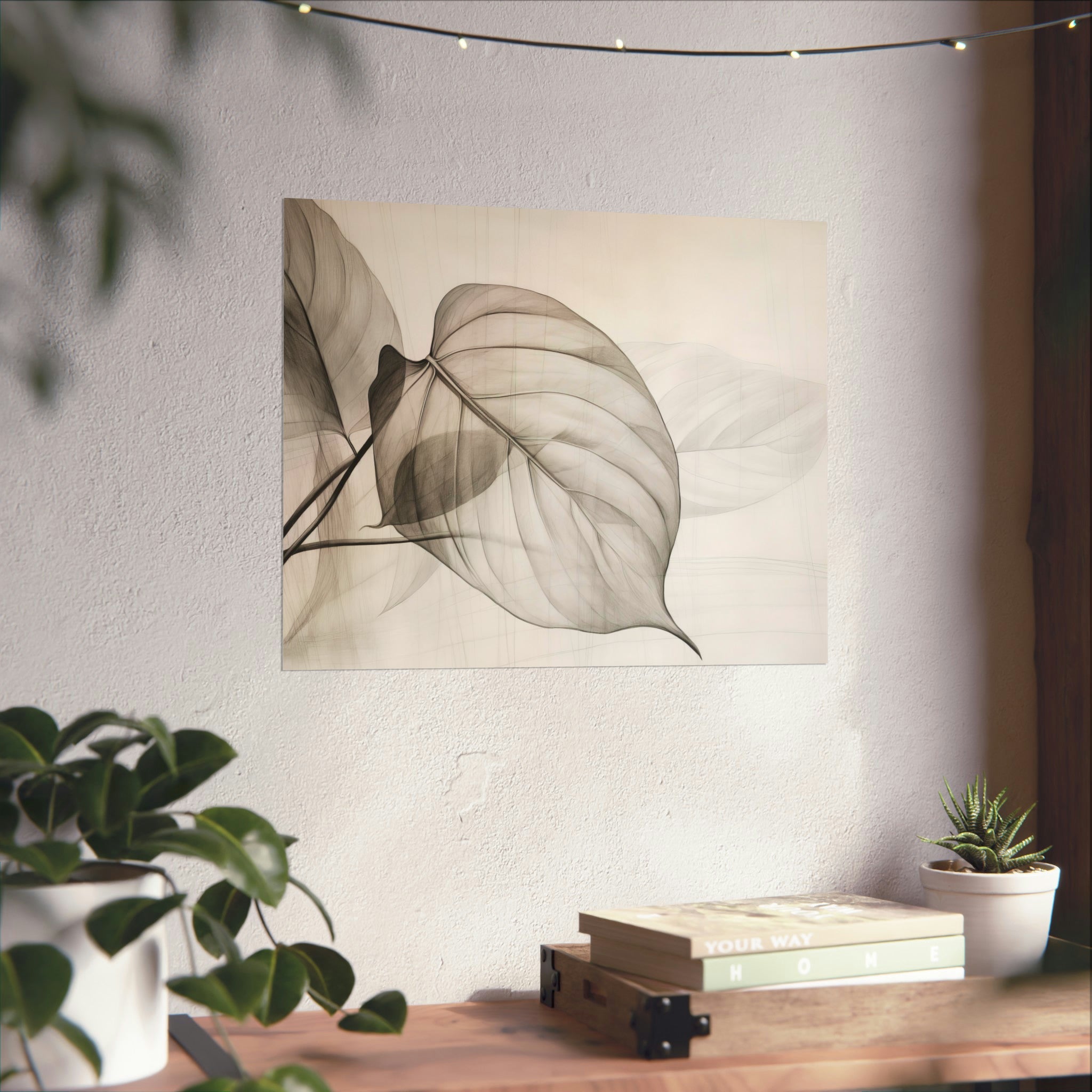 A tranquil corner featuring the Leaves Large Matte Poster printed by Printify in the USA on archival matte paper, displayed on a textured wall, complemented by indoor plants and a stack of books.