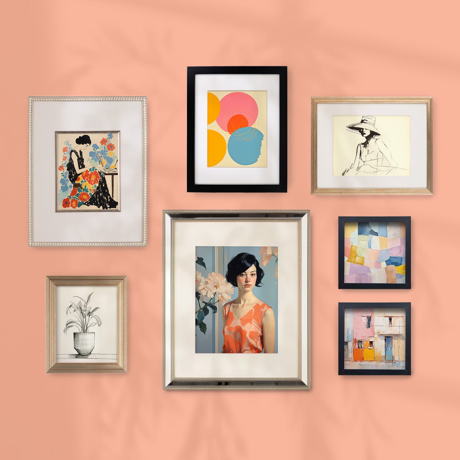 A Stannie & Lloyd gallery wall showcasing framed art on a peach wall.