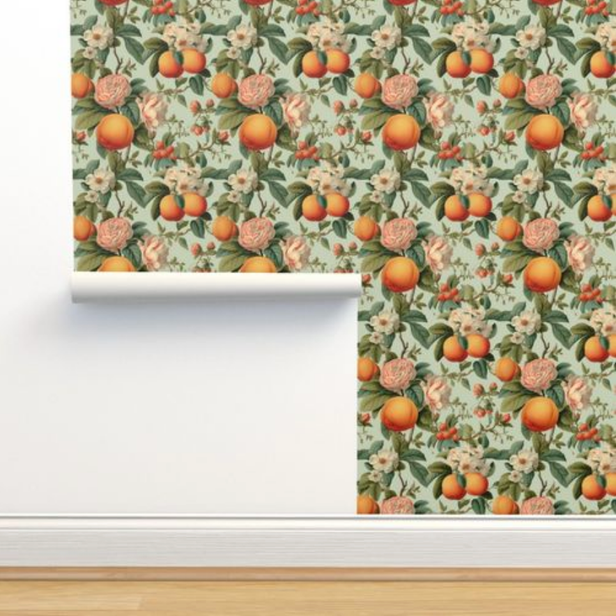 Roll of Vintage Orange Blossoms Wallpaper by Stannie & Lloyd with orange and peach tones, a piece of wall decor, being unrolled against a wall.