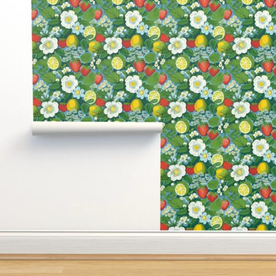 A colorful vintage art Fruit-themed wallpaper with a Strawberry Fields pattern, partially unrolled against a wall, from Stannie & Lloyd.