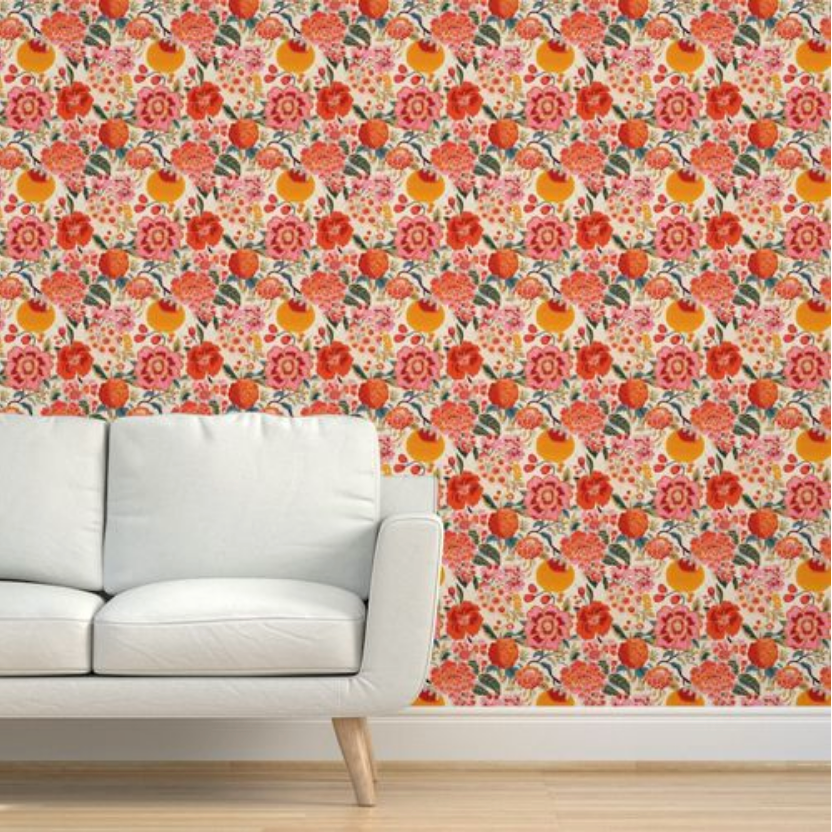 A modern sofa against a wall adorned with vibrant Pink Berries & Flowers Wallpaper by Stannie & Lloyd for living room.