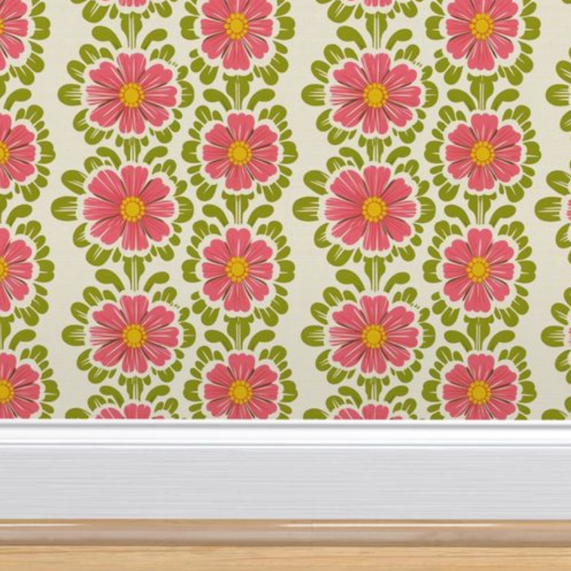 Wall art for living room includes Pink Pop Flowers Wallpaper by Stannie & Lloyd above a white baseboard on a wall.