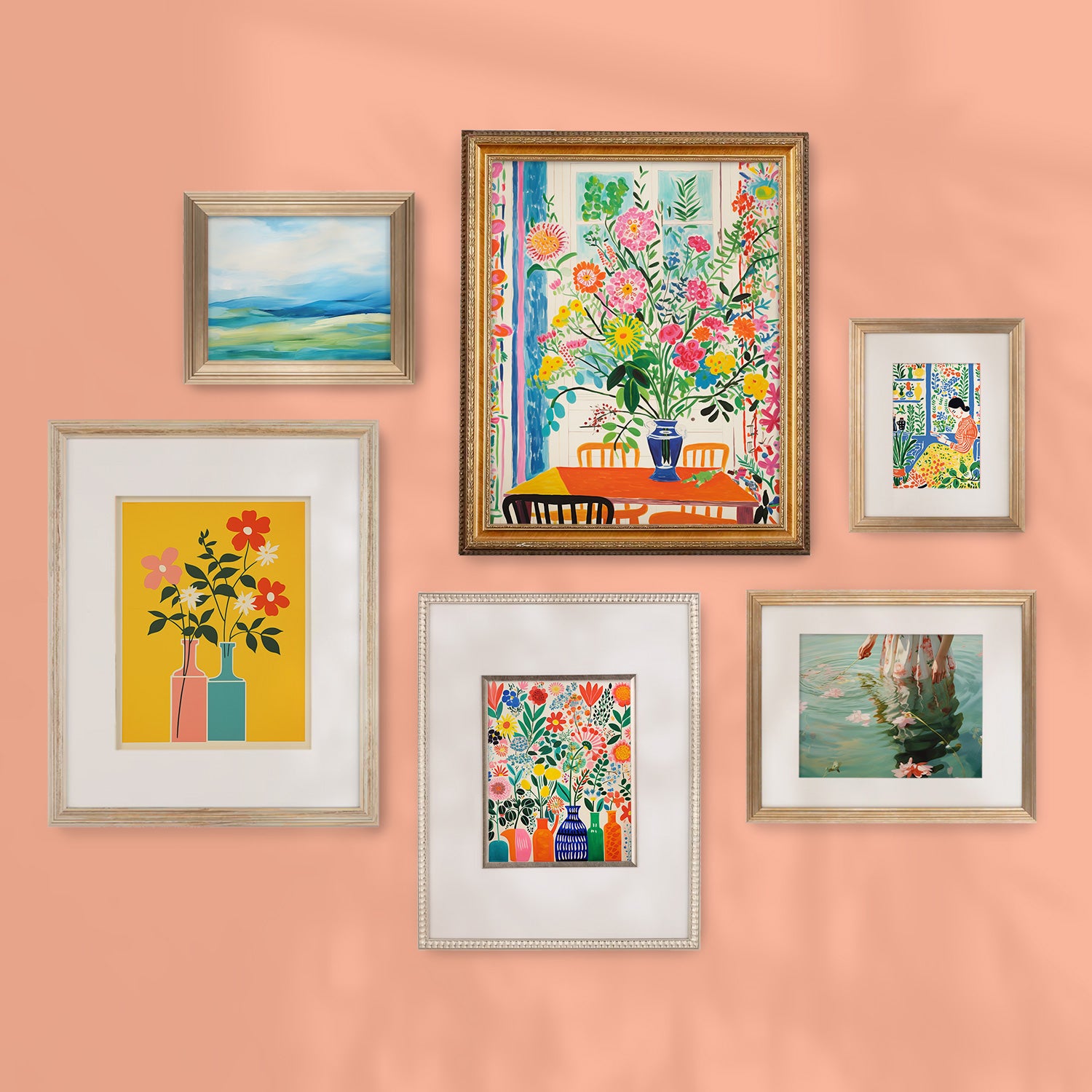 A Stannie & Lloyd gallery wall of colorful framed art on a peach wall, featuring the Don't Forget to Water the Flowers mix and match frames curated by designer Margot Wells.