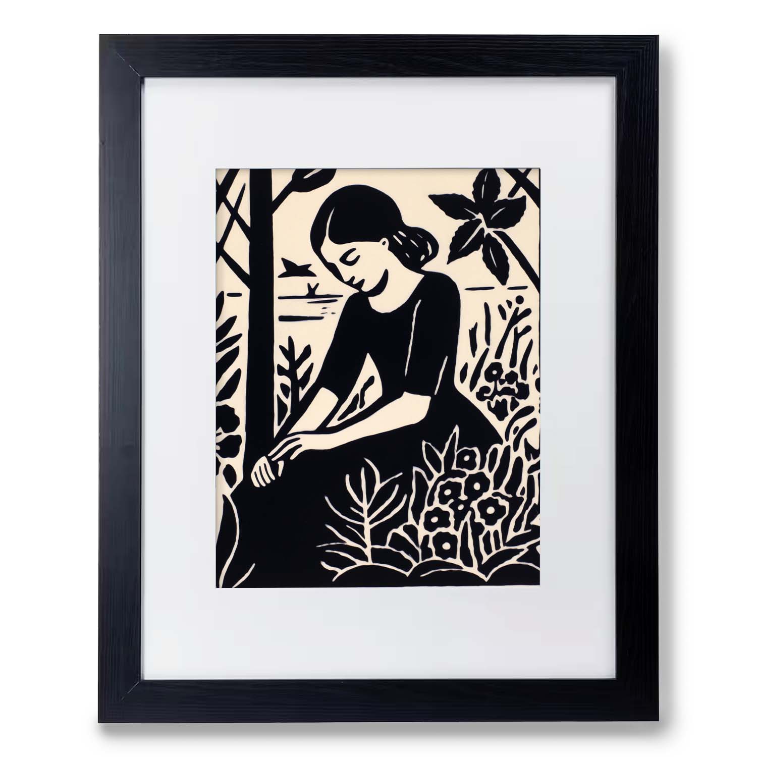 A black and white print of a woman in the forest, beautifully displayed in a Stannie & Lloyd "Seeds Planted" wood frame.